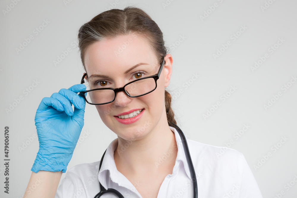female doctor or nurse is looking over her glasses female doctor or nurse is looking over her glasses