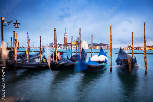 Gondolas moored by Saint Mark square with San Giorgio di Maggiore church in Venice