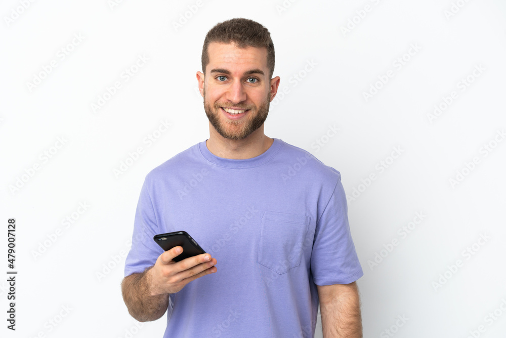 Young handsome caucasian man isolated on white background using mobile phone Young handsome caucasian man isolated on white background using mobile phone