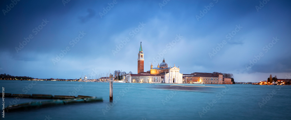 Gondolas moored by Saint Mark square with San Giorgio di Maggiore church in Venice