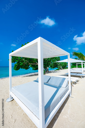 white bed on the sandy beach of the sea