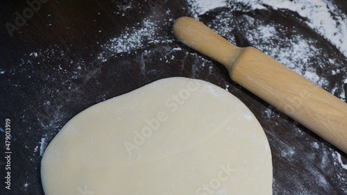 cooking process, modeling, recipe, dough, roll out with a wooden rolling pin, flour