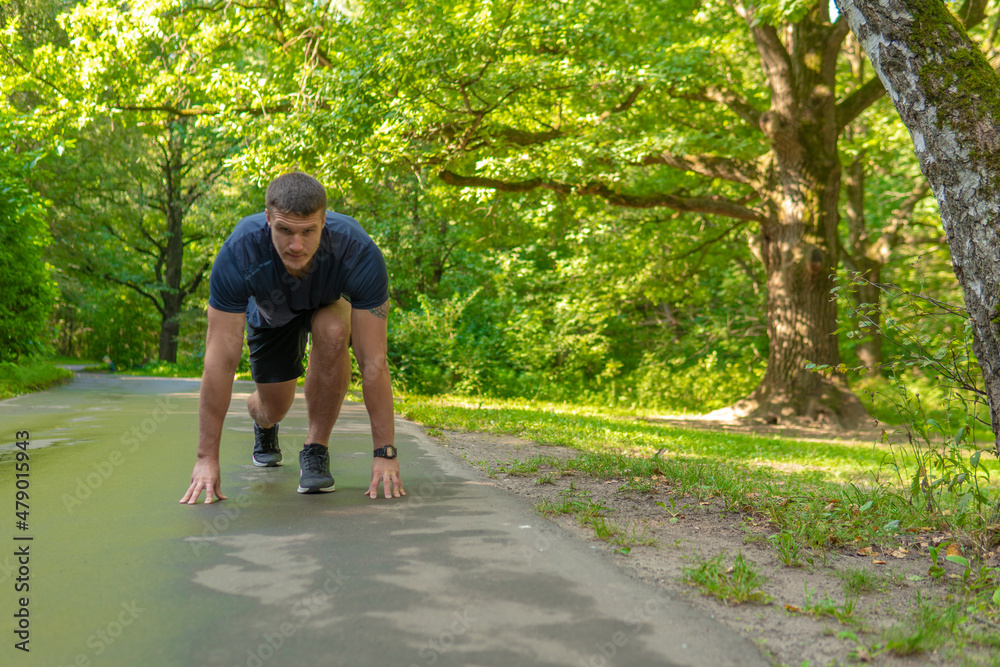A man athlete runs in the park outdoors, around the forest, oak trees green grass young enduring athletic athlete active runner exercise, outdoor young park outside. Autumn leisure spring, stretching A man athlete runs in the park outdoors, around the forest, oak trees green grass young enduring athletic athlete active runner exercise, outdoor young park outside. Autumn leisure spring, stretching