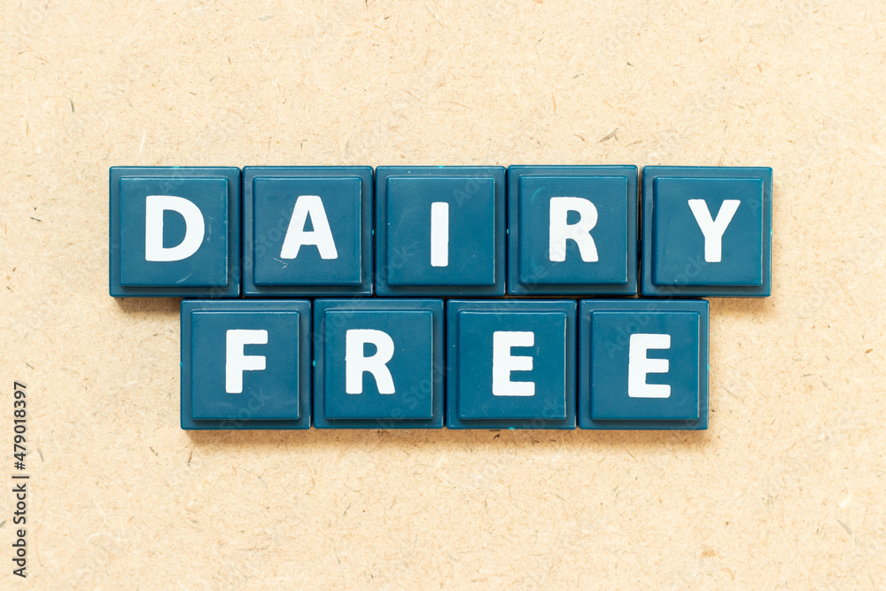 Tile alphabet letter in word dairy free on wood background Tile alphabet letter in word dairy free on wood background
