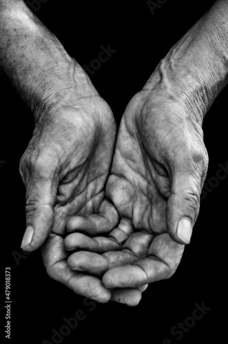 An elderly woman hands begging for food or help-Beggar and poverty concept, poor people, retirement pension.Black and white photo. Global financial crisic, hungry and no money background.