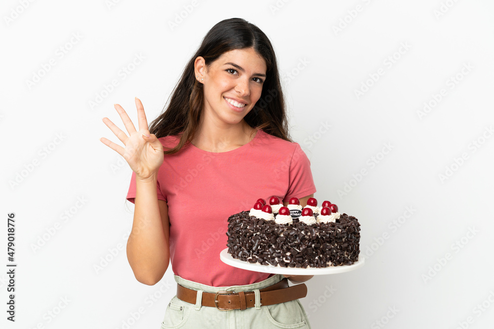 Young caucasian woman holding birthday cake isolated on white background happy and counting four with fingers Young caucasian woman holding birthday cake isolated on white background happy and counting four with fingers