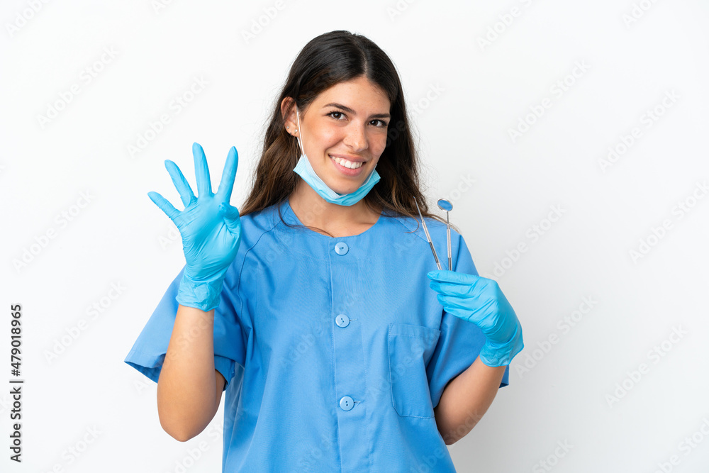 Dentist woman holding tools over isolated white background happy and counting four with fingers Dentist woman holding tools over isolated white background happy and counting four with fingers