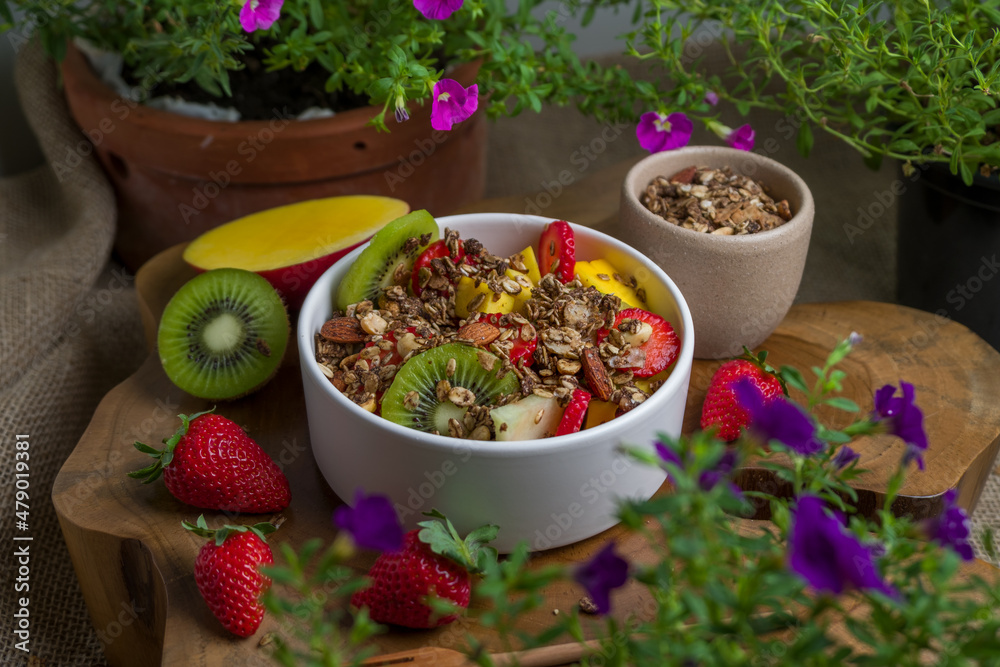 Tropical Salad of Fruits with mango, strawberry, kiwi, melon and granola Tropical Salad of Fruits with mango, strawberry, kiwi, melon and granola