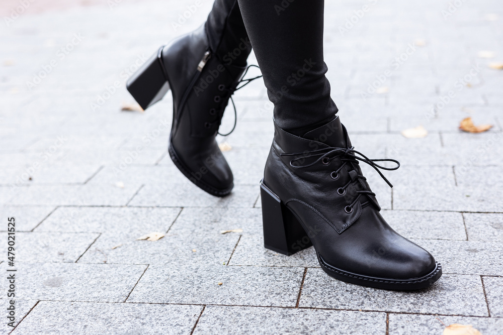 New collection of women's spring shoes. Slender female legs close-up in genuine leather boots. New collection of women's spring shoes. Slender female legs close-up in genuine leather boots.