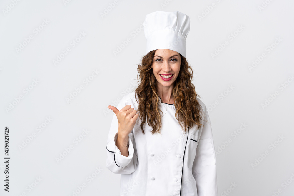 Young chef woman isolated on white background pointing to the side to present a product Young chef woman isolated on white background pointing to the side to present a product