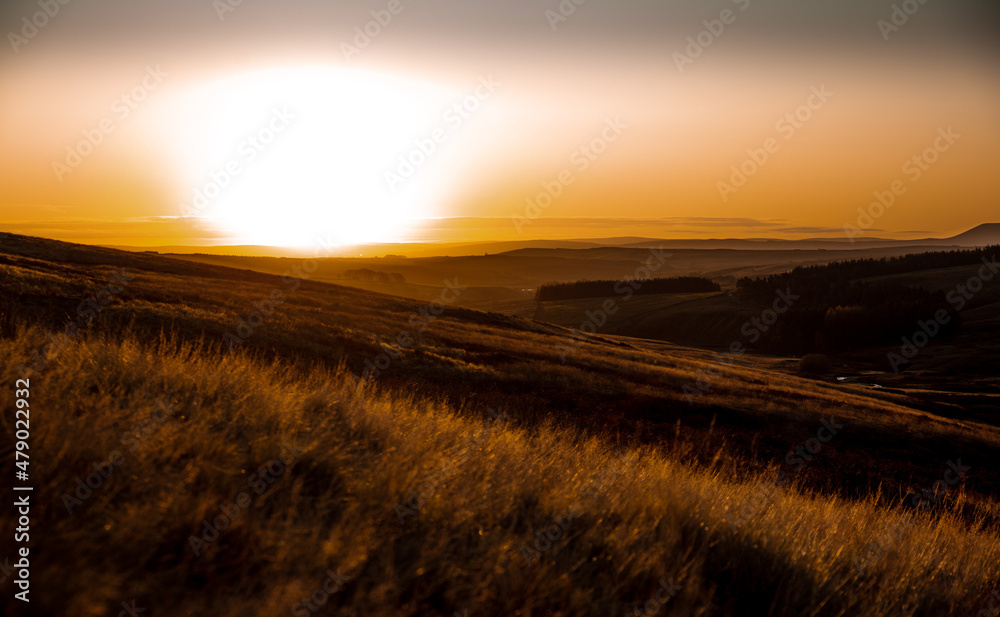 Sunset across moorland in Yorkshire orange tones.