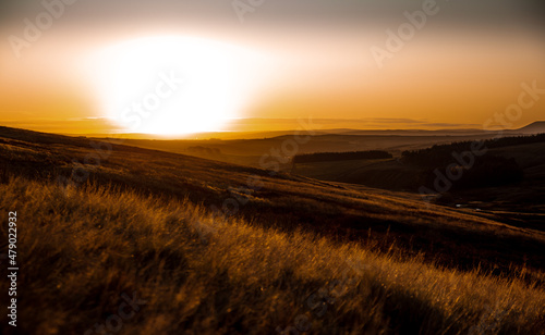 Sunset across moorland in Yorkshire orange tones.