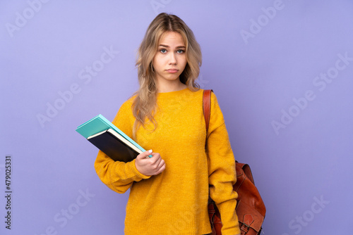 Teenager Russian student girl isolated on purple background with sad and depressed expression