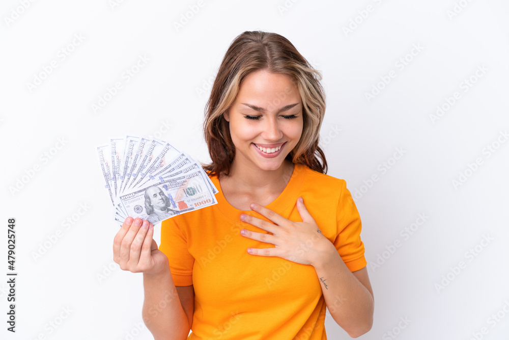 Young Russian girl holding dollars isolated on white background smiling a lot Young Russian girl holding dollars isolated on white background smiling a lot