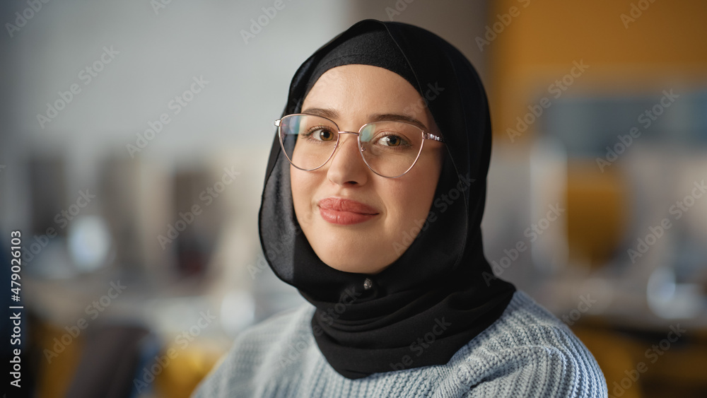 Beautiful Portrait of a Multiethnic Muslim Female Wearing Hijab and Glasses,  Charmingly Smiling and Posing on Camera. Happy Diverse Young Woman in  Casual Clothes Indoors. Stock Photo | Adobe Stock