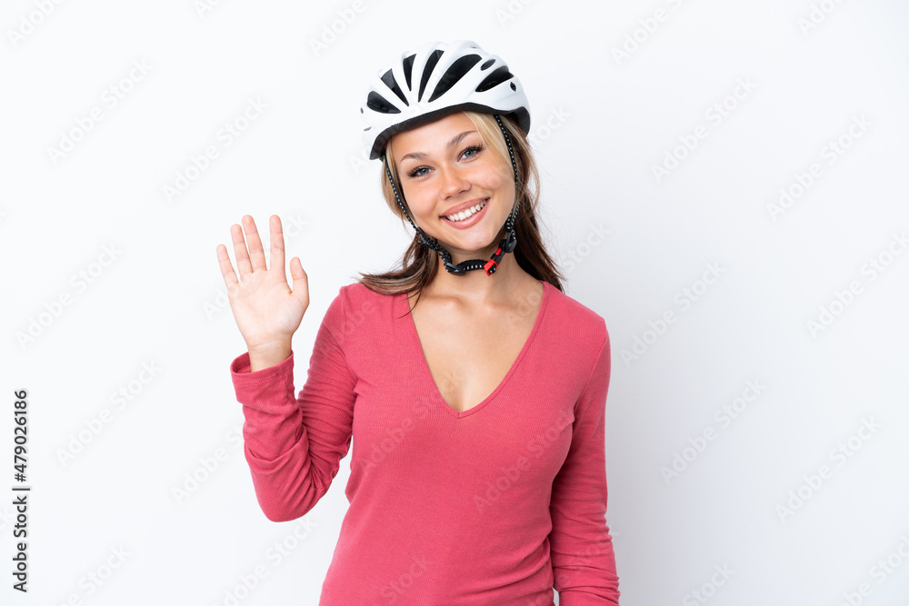 Young Russian woman wearing a bike helmet isolated on white background saluting with hand with happy expression Young Russian woman wearing a bike helmet isolated on white background saluting with hand with happy expression