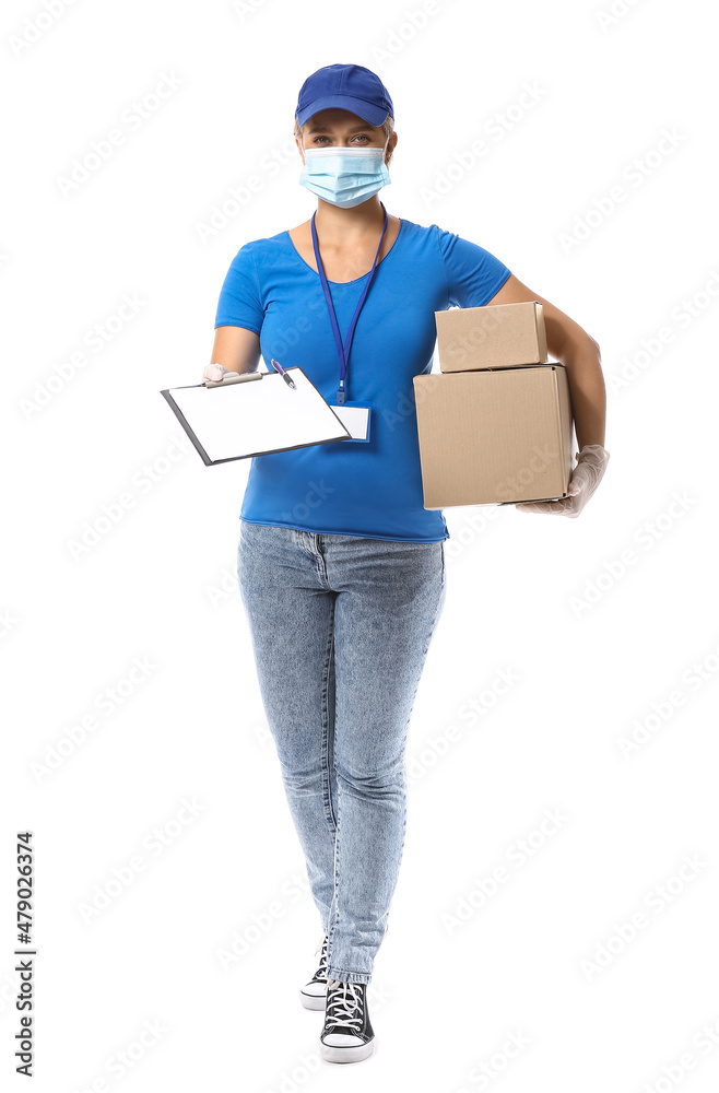Female courier in medical mask and with parcels on white background