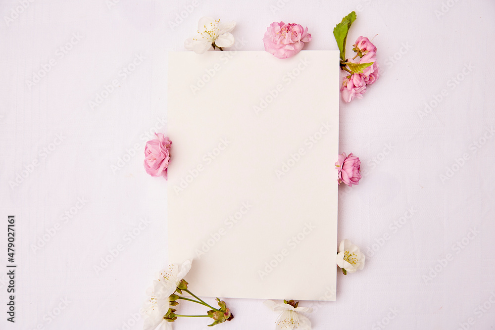 Feminine stationery card mockup with spring white and pink flowers. Romantic, wedding, birthday, invitation, mother's day mock up card concept. Copy space. Top view Feminine stationery card mockup with spring white and pink flowers. Romantic, wedding, birthday, invitation, mother's day mock up card concept. Copy space. Top view