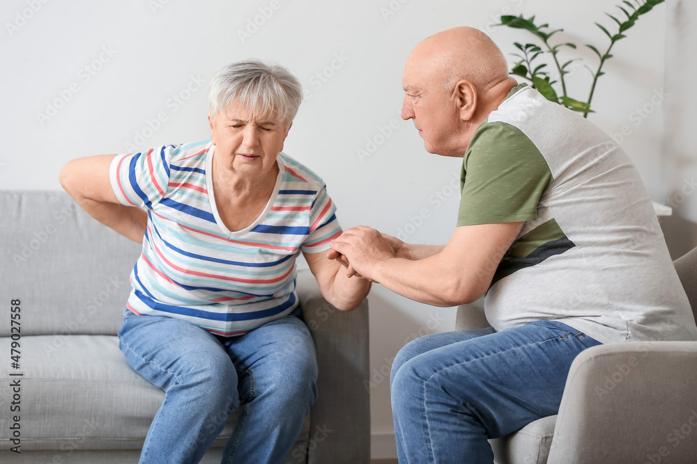 Senior man with his wife suffering from back pain at home Senior man with his wife suffering from back pain at home