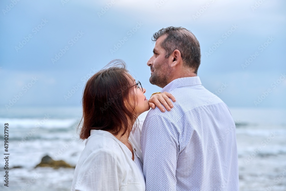 Outdoor portrait of mature couple hugging on the seashore Outdoor portrait of mature couple hugging on the seashore