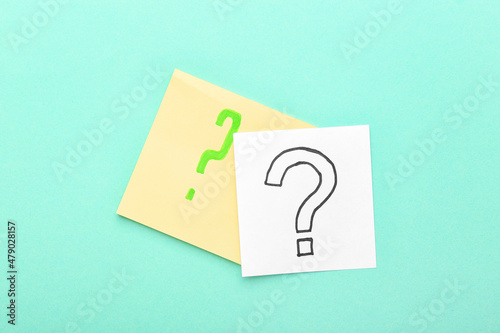 Sticky notes with question marks on blue background