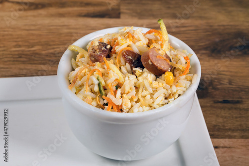 Biro-Biro rice or “arroz maluco”. type of rice typical of Brazilian food. Rice with straw potatoes, scrambled egg and bacon