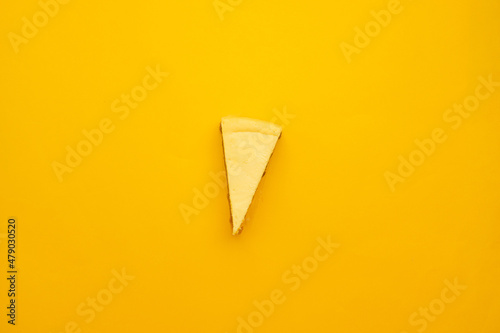 Fotografie, Obraz Piece of tasty cream cheesecake on yellow background