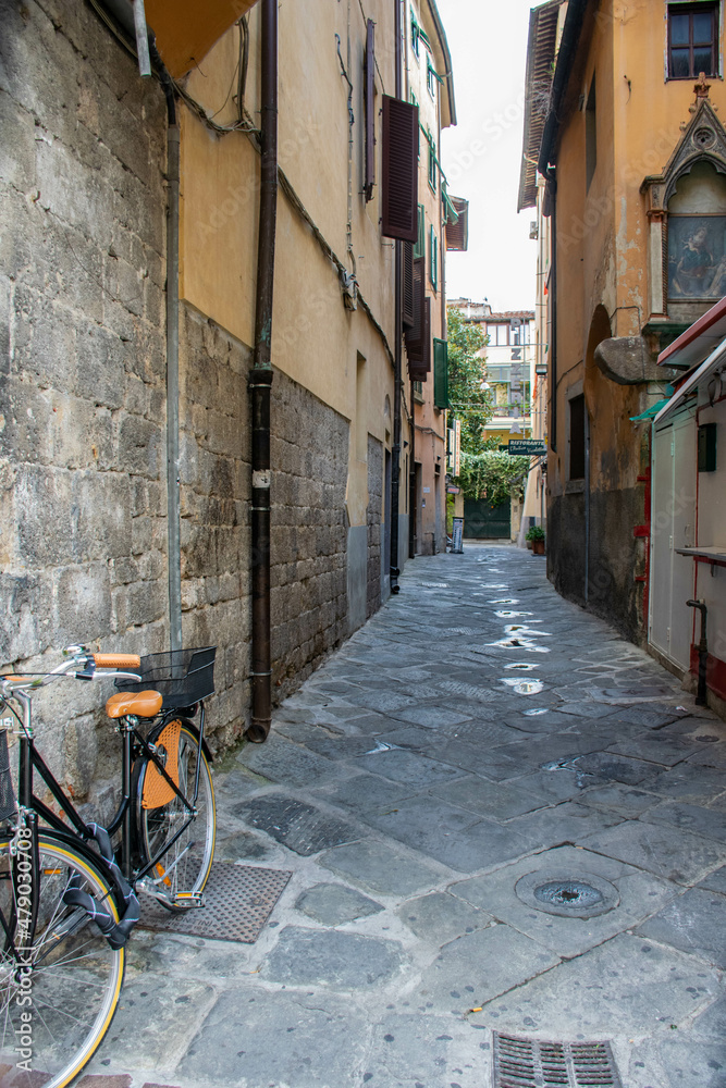 Pisa, Italy, September 2015, a deserted side street of the city of Pisa with a parked bike
