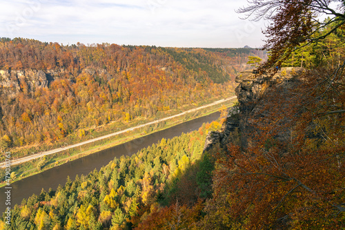 High angle view of Elbe Sandstone Mountains national park, Czech Republic. Canyon of river Labe surrounded by sandstone rock formations in autumn. Colorful autumnal trees on sunny day
