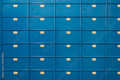 Postcode lockers in blue and plate with the identification number
