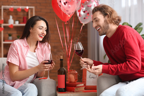 Happy young couple drinking...