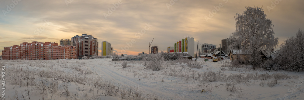 panorama of a large construction site illuminated by the setting sun on a frosty winter evening panorama of a large construction site illuminated by the setting sun on a frosty winter evening