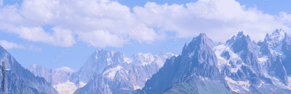 high mountains, rocky cliffs with trees, in the background you can see the French Alps with the snow-capped Mont Blanc, the concept of hiking, rock climbing, active lifestyle, beauty of nature