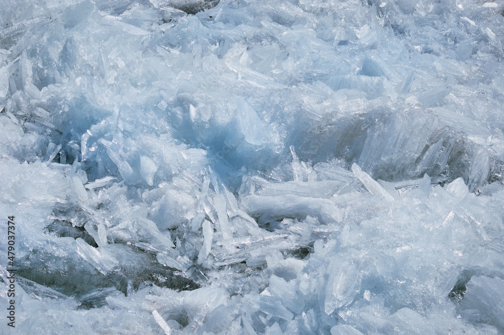 Melting river ice. Columnar and needle-like structure of crystals. Ice floe in the spring on the banks of the Amur River. Melting river ice. Columnar and needle-like structure of crystals. Ice floe in the spring on the banks of the Amur River.