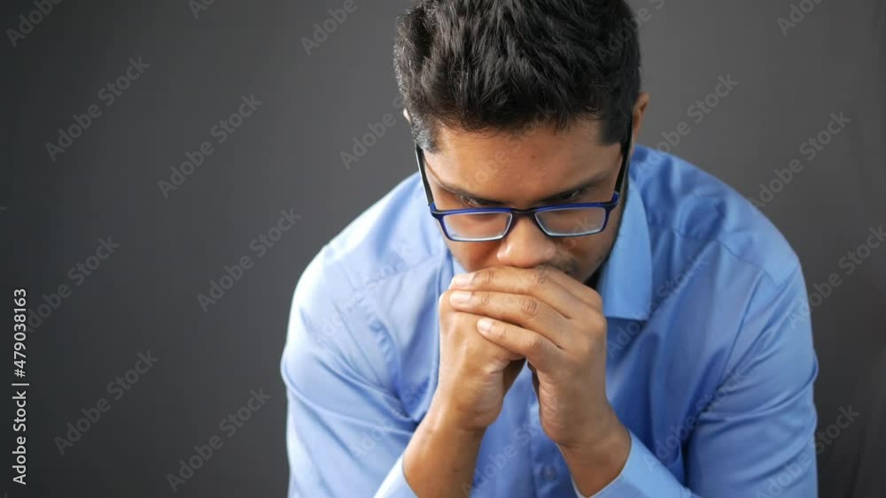 Worried business man face looking down close up Worried business man face looking down close up