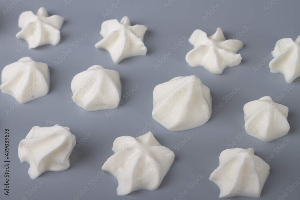 Whipped cream is applied with roses on a gray background. Copy Space Whipped cream is applied with roses on a gray background. Copy Space