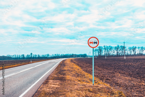 Overtaking is prohibited. It is forbidden to indicate in advance. Round red road sign. photo