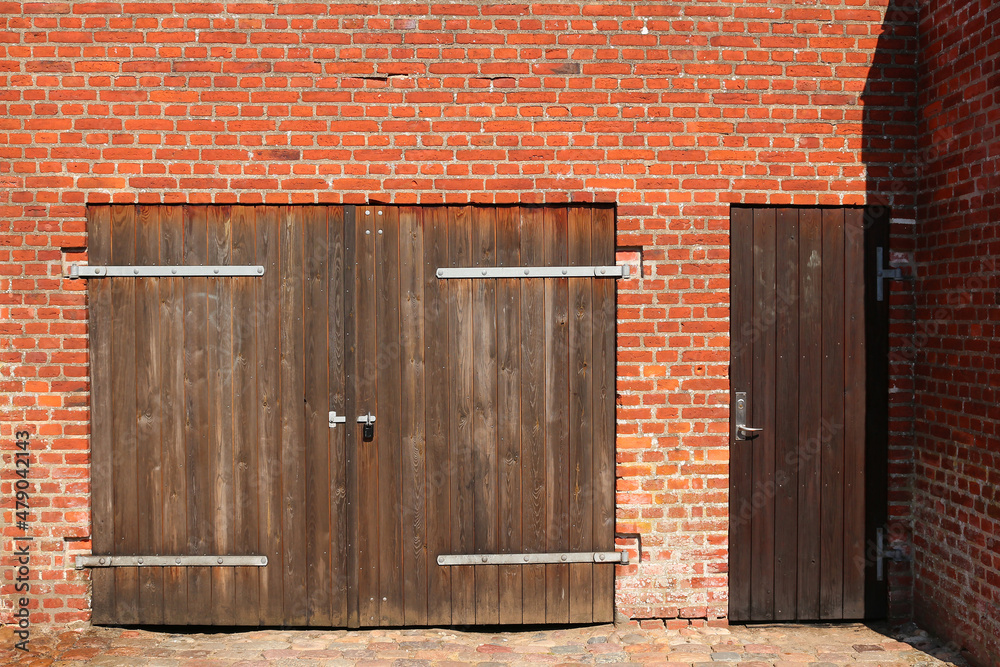 Wooden garage door in typical danish red brick stone building