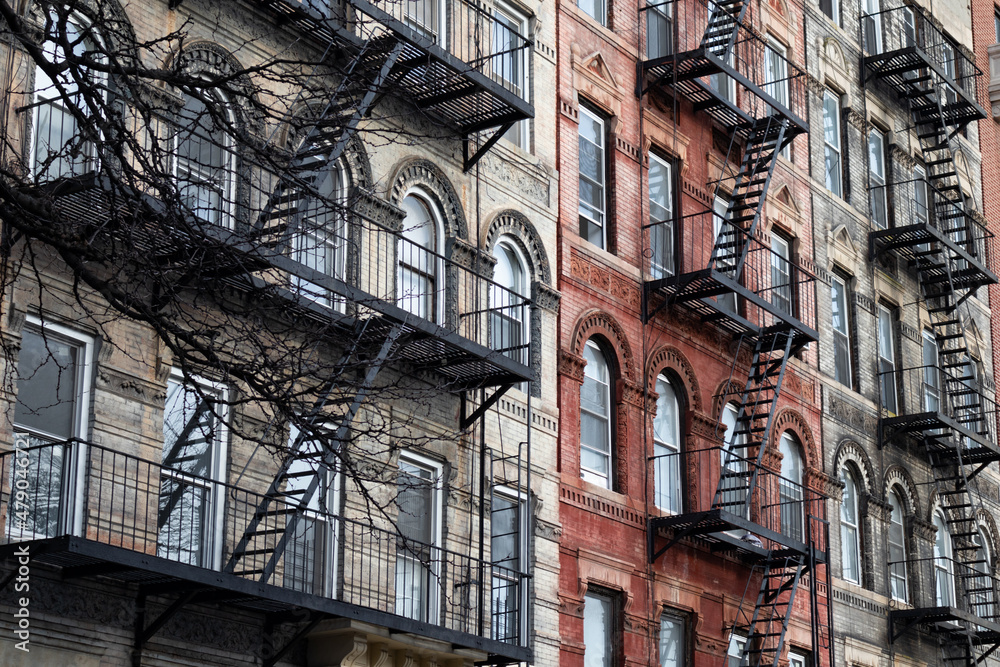 Row of Colorful Old Residential Buildings in the East Village of New York City with Fire Escapes