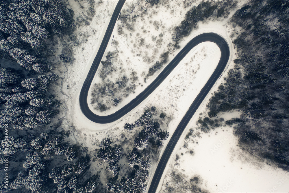 Aerial view of a curved mountain road in Europe.