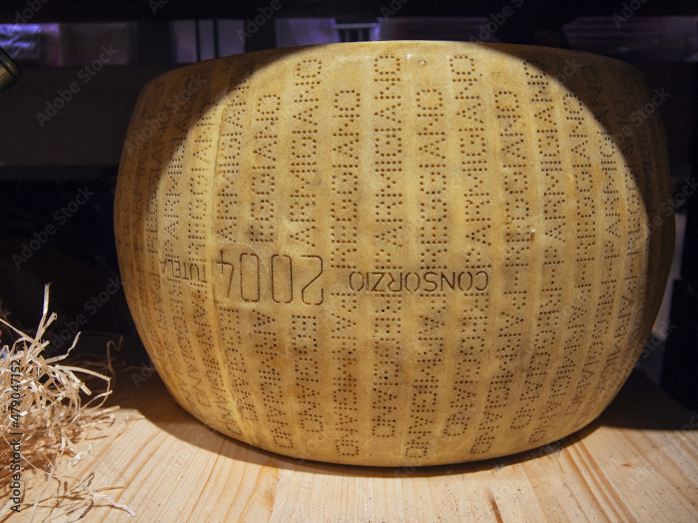 Parmigiano Reggiano cheese wheel. Italian seasoned cheese. Stock Photo
