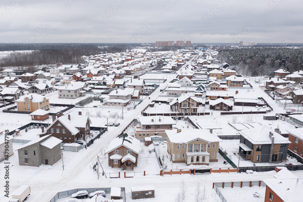 Aerial view of modern cottage village in Moscow region in winter, Russia