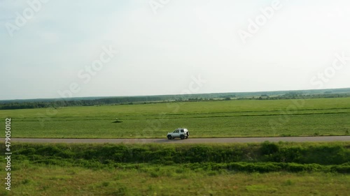 Aerial view of a car driving on a country road