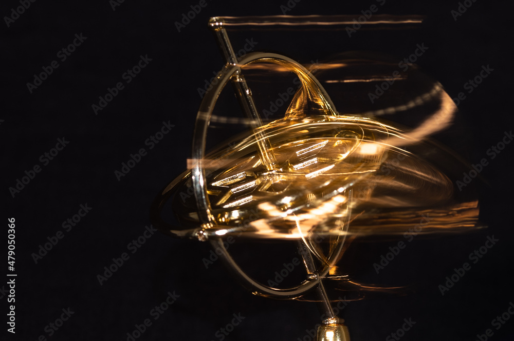 Golden Gyroscope Spinning Wildly on its Base