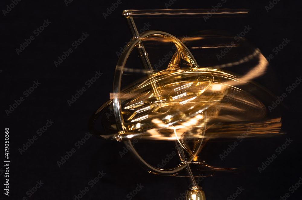 Golden Gyroscope Spinning Wildly on its Base Golden Gyroscope Spinning Wildly on its Base