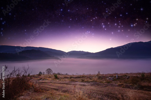 Mountain landscape, dawn or sunset and starry sky.