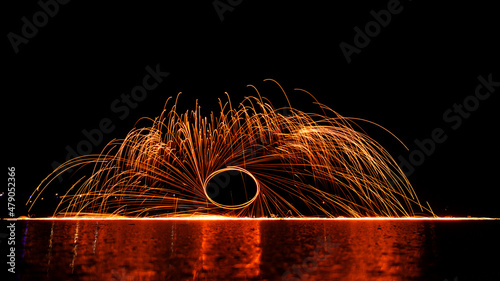 Night fire dance. Sparks from steel wool on a black background. Close-up.