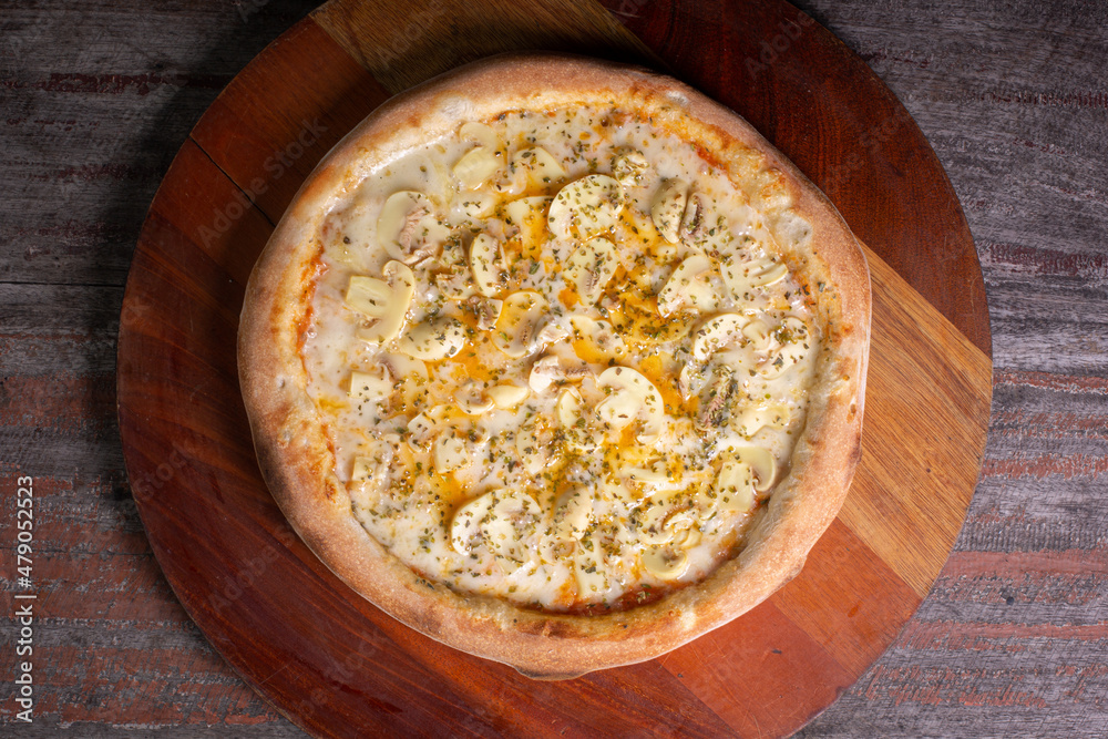 Tasty Mushroom Pizza on wooden background, in Brazil it's called pizza de cogumelos Tasty Mushroom Pizza on wooden background, in Brazil it's called pizza de cogumelos