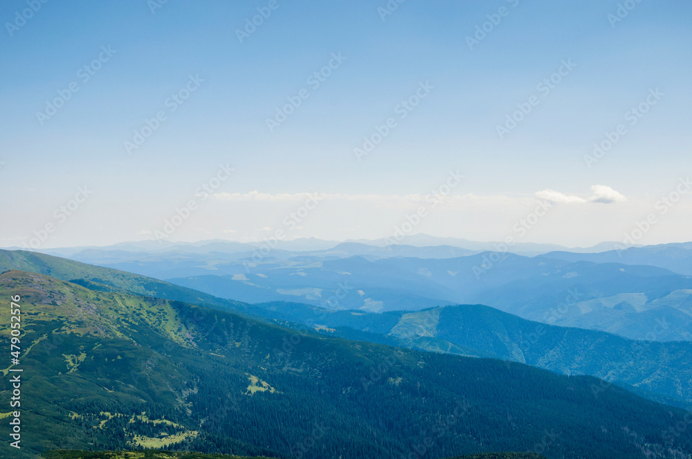 silhouettes of mountain peaks in the morning blue fog, beautiful landscape, travel. High quality photo