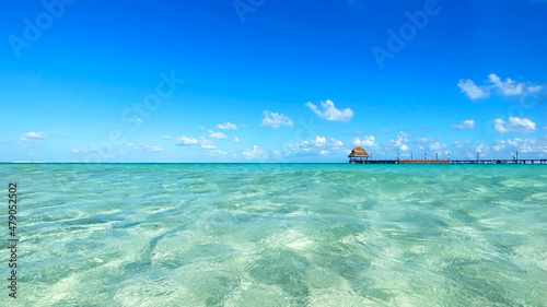 Isla Mujeres beach with blue sky and clear water.